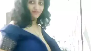 Busty MILF removing blouse and showing big boobs