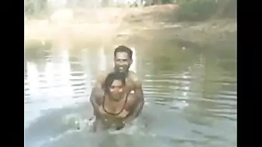 Village couple outdoor bath in pond