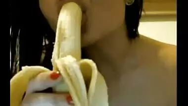 Naughty Indian babe sucking a banana on camera