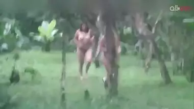 Two hot and sexy Desi aunty bathing in a outdoor under rain together