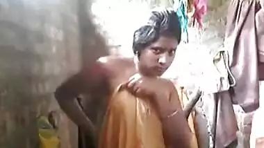 Indian village wife undressing and taking bath