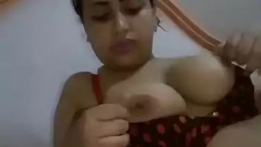 Beautiful girl playing with her big round boobs