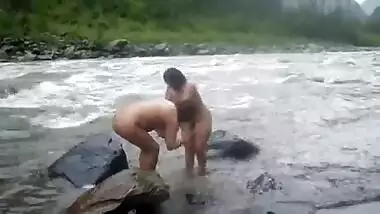 Two nude aunties taking bath in a river