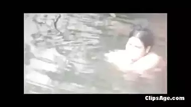 Big boobed desi MILF undressing and bathing in pond hidden cam video