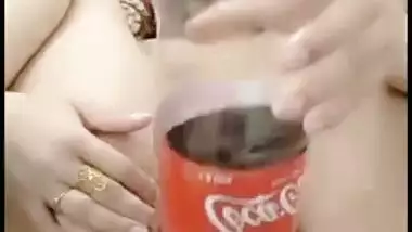 Delhi girl pushes a coca cola bottle in her cunt