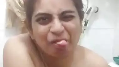 Desi female sits on a toilet bowl with naked XXX boobies and pussy