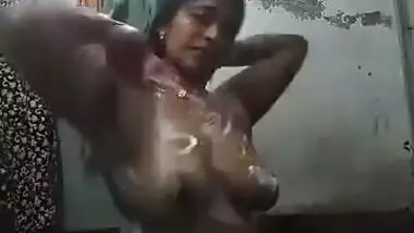 Female with Indian features soaps up her sex parts washing XXX body
