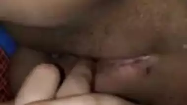 Indian woman touches her pink vagina with two hands in close-up porn